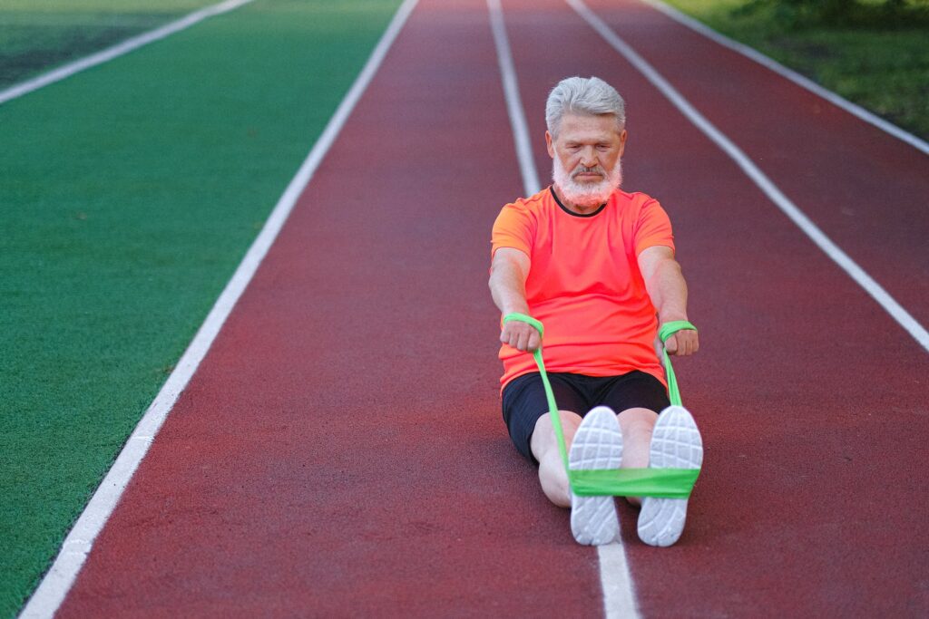 Active senior man stretching with elastic rubber